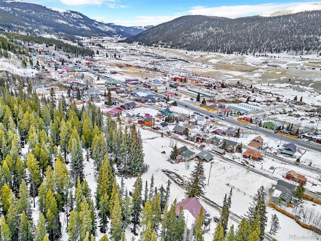 snowy aerial view featuring a mountain view