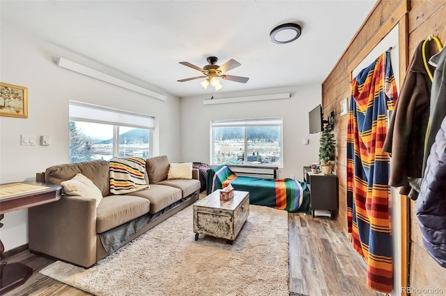 living room with wood-type flooring and ceiling fan