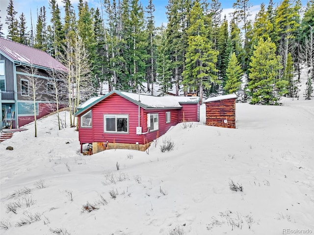 view of snow covered back of property