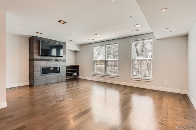 1840 Irving St, Denver, CO 80204 - unfurnished living room featuring baseboards, a fireplace, wood finished floors, and recessed lighting
