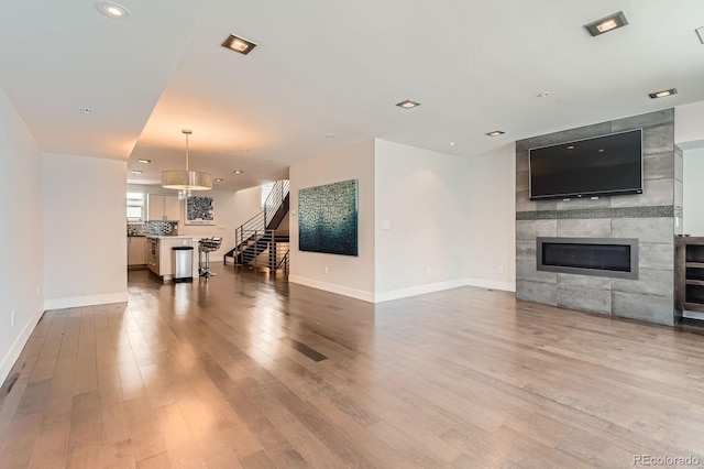 1840 Irving St, Denver, CO 80204 - living room with wood finished floors, baseboards, a fireplace, stairway, and recessed lighting