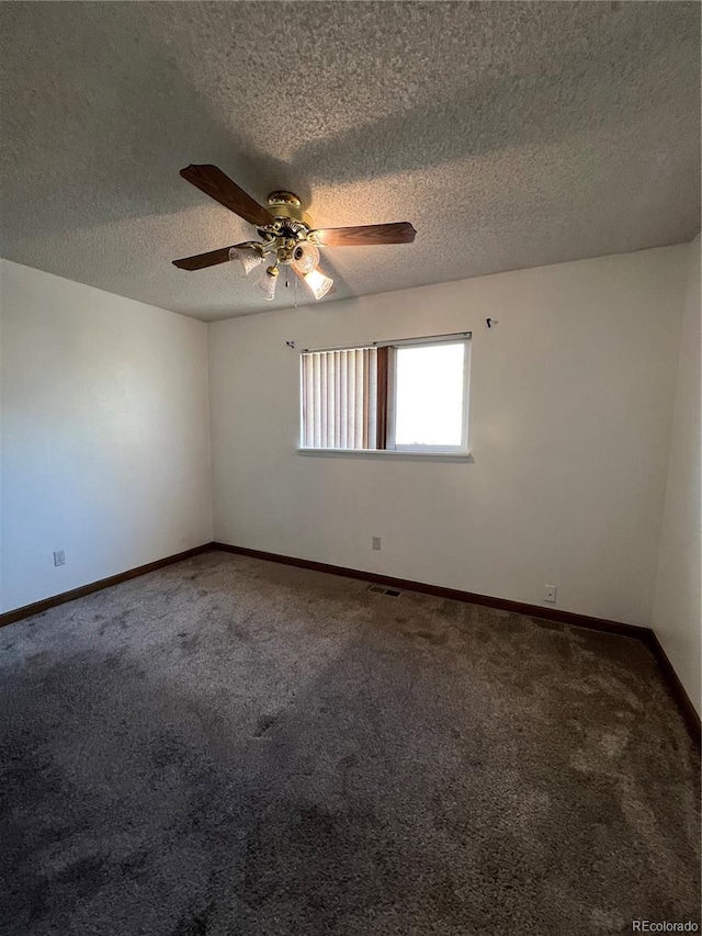 carpeted empty room featuring ceiling fan and a textured ceiling