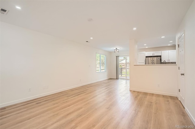1272 Bluebird St, Brighton, CO 80601 - unfurnished living room with light wood finished floors and recessed lighting