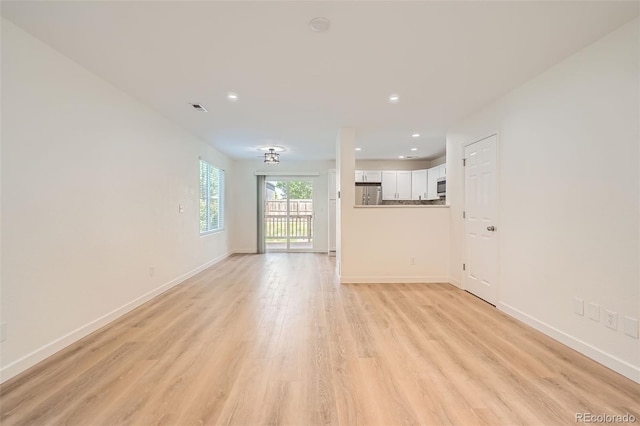 1272 Bluebird St, Brighton, CO 80601 - unfurnished living room with light wood-style flooring and recessed lighting