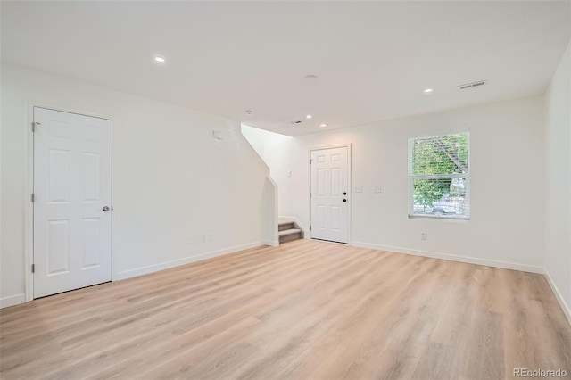 1272 Bluebird St, Brighton, CO 80601 - empty room featuring light wood finished floors, recessed lighting, and stairs