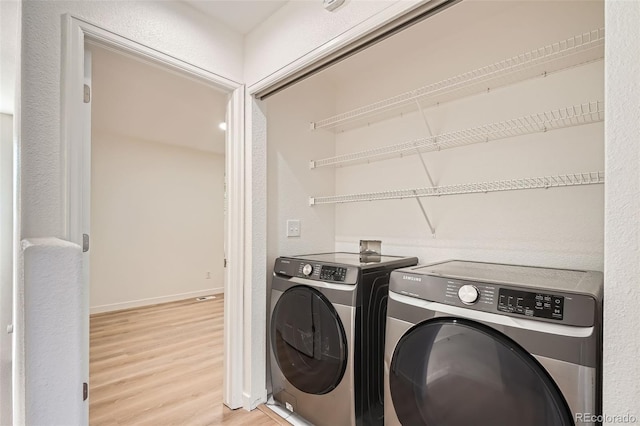 1272 Bluebird St, Brighton, CO 80601 - laundry room featuring separate washer and dryer and light wood-style flooring