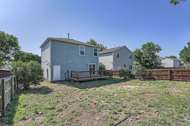 1272 Bluebird St, Brighton, CO 80601 - rear view of house with a fenced backyard and a deck