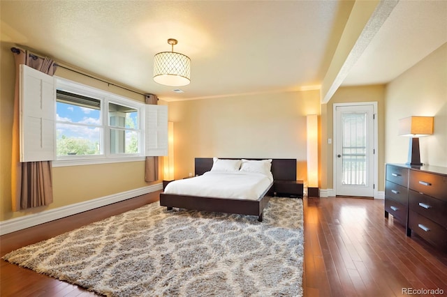 bedroom featuring dark hardwood / wood-style flooring and multiple windows