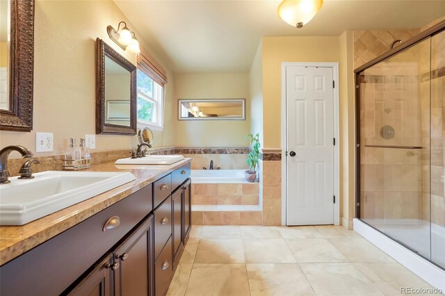 bathroom featuring tile patterned floors, vanity, and shower with separate bathtub