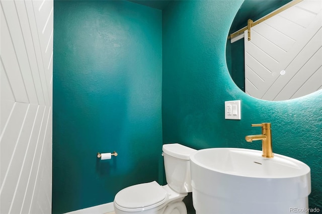 bathroom featuring sink and toilet