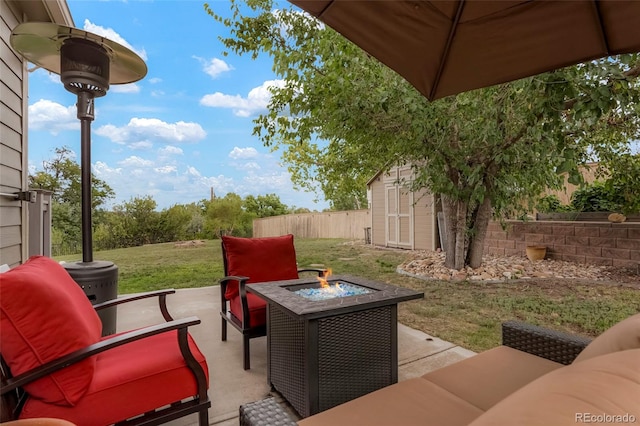 view of patio featuring an outdoor living space with a fire pit and a storage shed