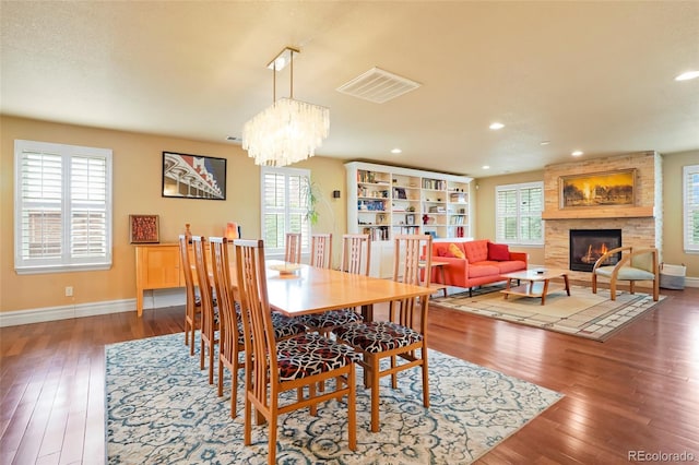 dining space with dark wood-type flooring and a wealth of natural light