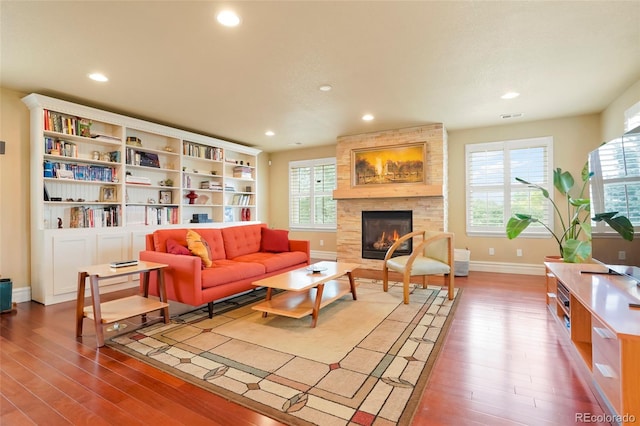 living room featuring a fireplace, hardwood / wood-style floors, and a healthy amount of sunlight