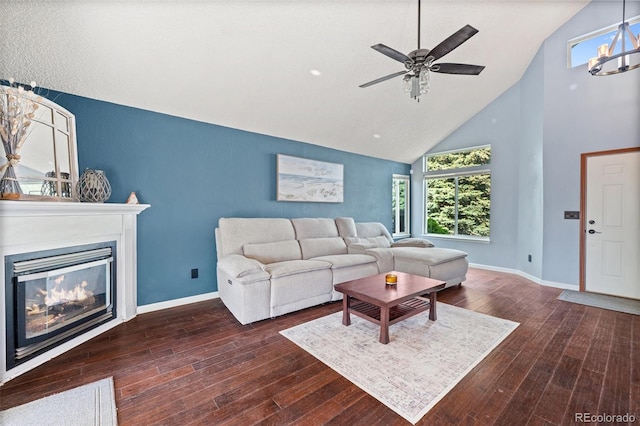 3904 Breaking Dawn St, Colorado Springs, CO 80925 - living area with high vaulted ceiling, a glass covered fireplace, wood-type flooring, baseboards, and a ceiling fan