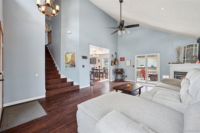 3904 Breaking Dawn St, Colorado Springs, CO 80925 - living room featuring a chandelier, stairway, hardwood / wood-style flooring, high vaulted ceiling, and a textured ceiling