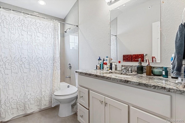 full bathroom featuring tile patterned floors, shower / bath combo with shower curtain, vanity, and toilet