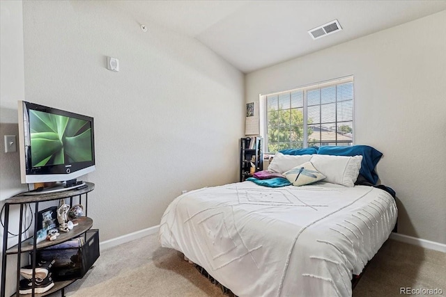 bedroom with light carpet and vaulted ceiling