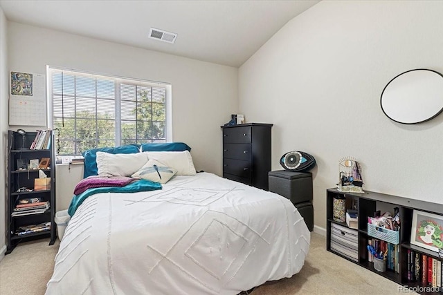 bedroom featuring light carpet and lofted ceiling