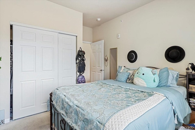 bedroom featuring light carpet and a closet