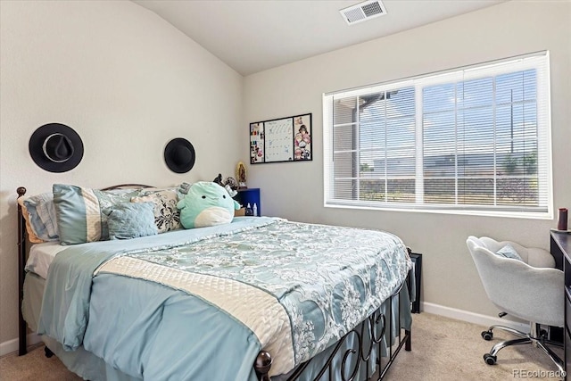 carpeted bedroom featuring multiple windows and vaulted ceiling