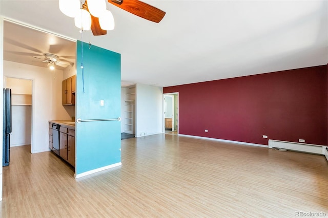 unfurnished living room with baseboard heating, baseboards, a ceiling fan, and light wood-style floors