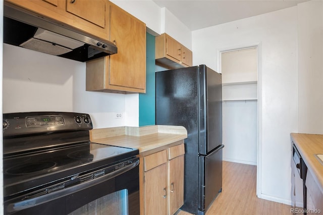 kitchen featuring light wood finished floors, under cabinet range hood, and black appliances