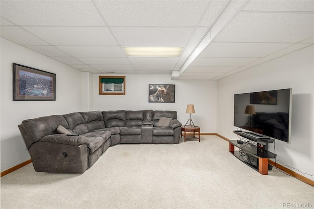 living room featuring carpet flooring and a drop ceiling