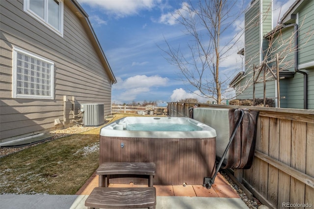 view of patio with a hot tub and central AC unit