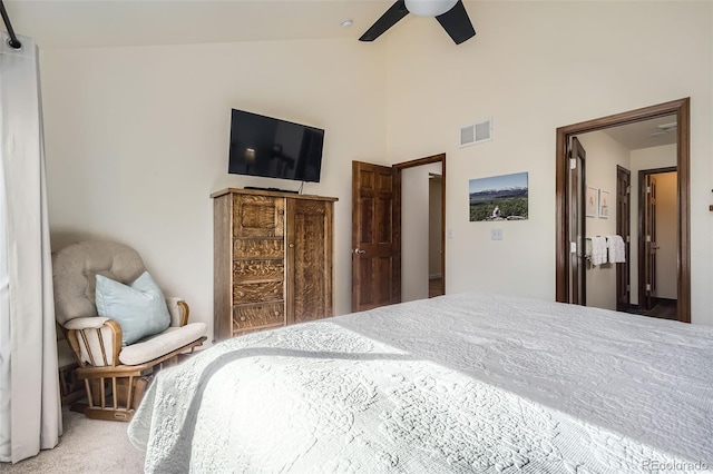 carpeted bedroom featuring vaulted ceiling, visible vents, and a ceiling fan