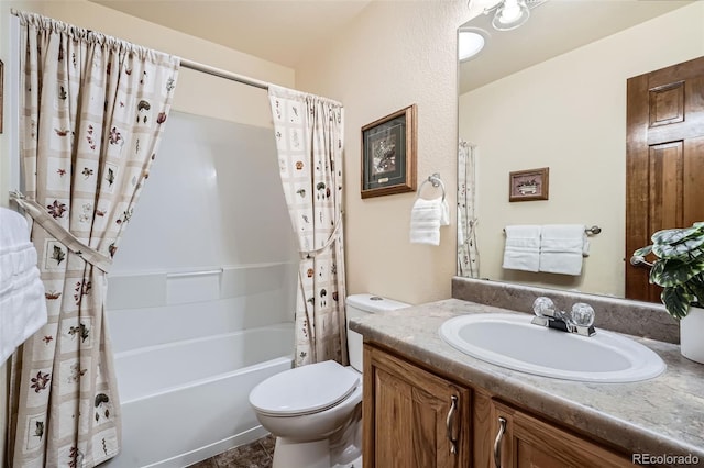 bathroom featuring toilet, shower / bath combo, and vanity