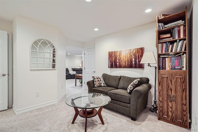 living area with recessed lighting, baseboards, and light colored carpet