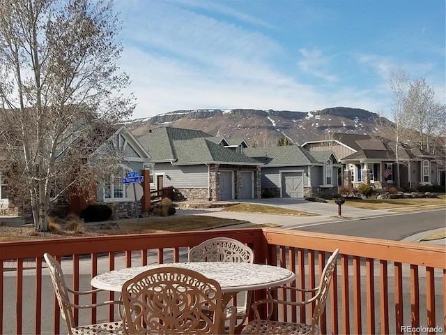 exterior space with a garage, a residential view, and a mountain view