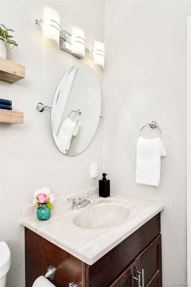 bathroom with toilet and vanity