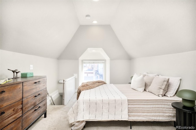 bedroom featuring light carpet, vaulted ceiling, and baseboards