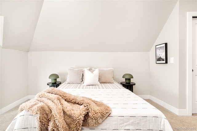 bedroom with carpet, lofted ceiling, and baseboards