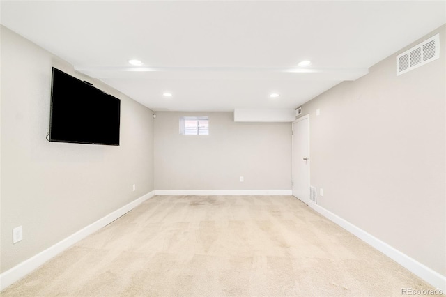 basement featuring recessed lighting, light colored carpet, visible vents, and baseboards