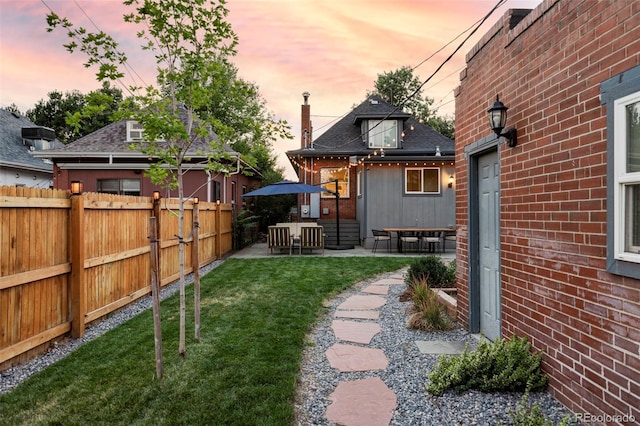 view of yard with fence and a patio