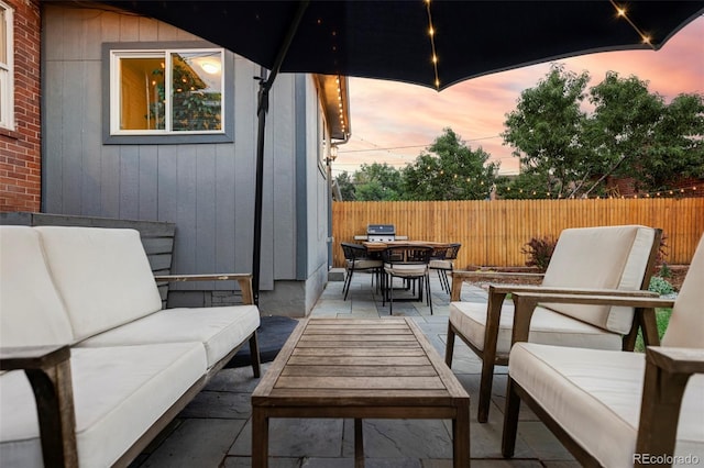 view of patio / terrace featuring an outdoor hangout area, outdoor dining space, and fence