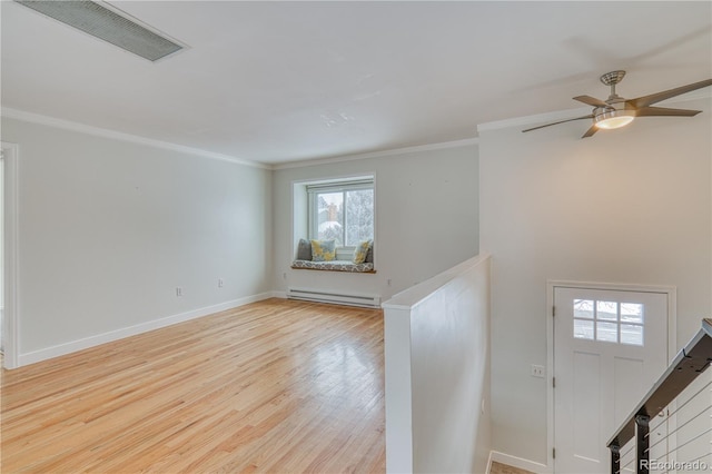 entryway featuring light wood-type flooring, visible vents, a baseboard heating unit, and crown molding