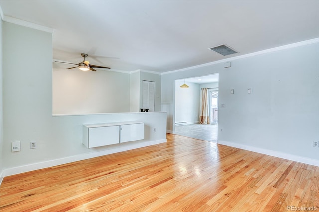 unfurnished room featuring baseboards, light wood-type flooring, and crown molding