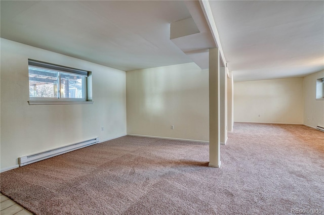 unfurnished room featuring baseboards, light colored carpet, and baseboard heating