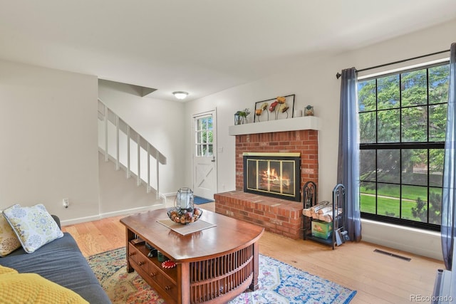 10310 E Jewell Ave Unit 55, Aurora, CO 80247 - living area featuring wood finished floors, stairs, a fireplace, and baseboards