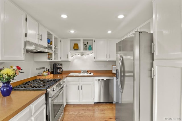 10310 E Jewell Ave Unit 55, Aurora, CO 80247 - kitchen with appliances with stainless steel finishes, under cabinet range hood, open shelves, a sink, and white cabinets