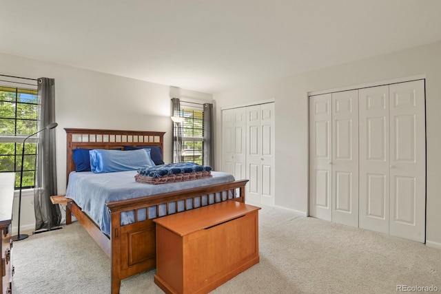 10310 E Jewell Ave Unit 55, Aurora, CO 80247 - carpeted bedroom with multiple windows, multiple closets, and baseboards