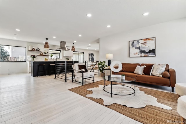 living room with light wood-type flooring and recessed lighting