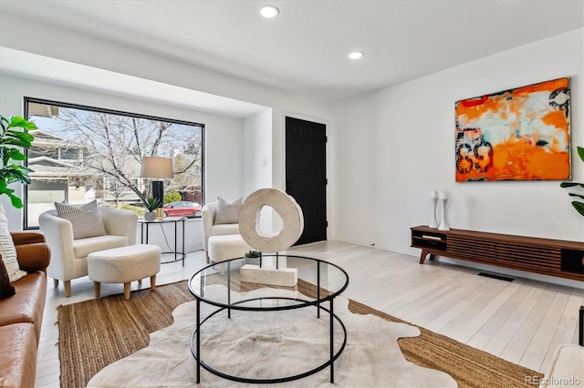 living area with light wood-style floors and recessed lighting