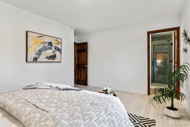 bedroom featuring baseboards and wood finished floors