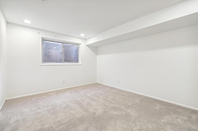 carpeted empty room featuring baseboards and recessed lighting