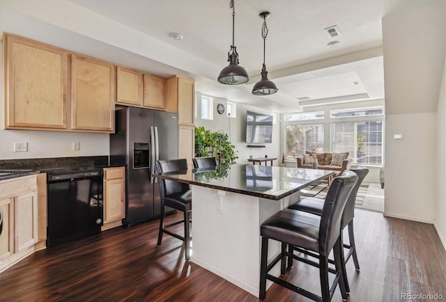 kitchen featuring decorative light fixtures, stainless steel fridge with ice dispenser, dishwasher, a breakfast bar area, and dark hardwood / wood-style flooring