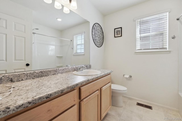 bathroom with vanity, tile patterned flooring, and toilet